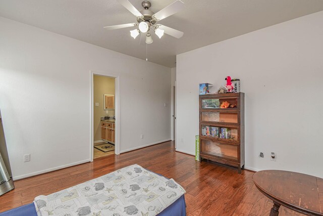 living area with dark hardwood / wood-style flooring and ceiling fan