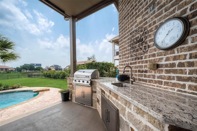 view of patio / terrace featuring area for grilling and sink