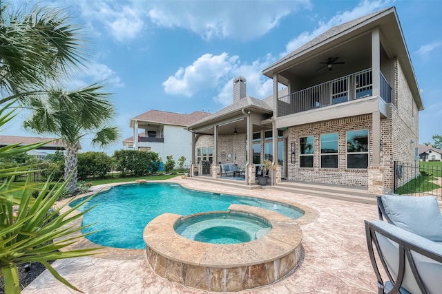 view of swimming pool featuring a patio area, ceiling fan, and an in ground hot tub