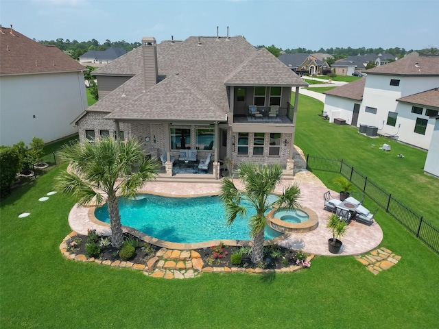 view of pool featuring an in ground hot tub, a yard, and a patio area