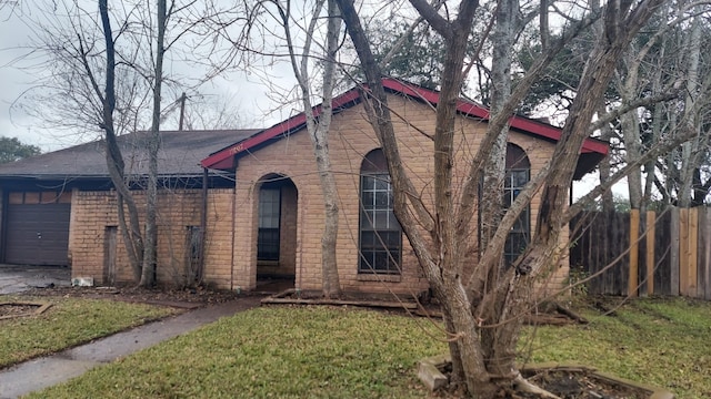 view of front of property with a garage and a front yard