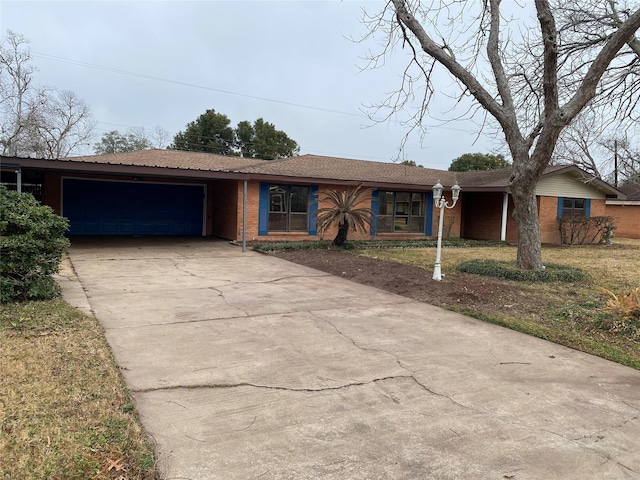 ranch-style house with a garage and a front yard