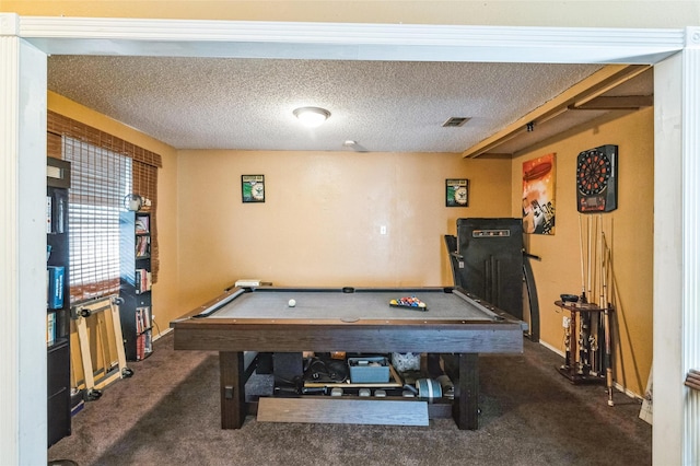 recreation room with pool table, a textured ceiling, and dark carpet