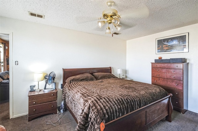 carpeted bedroom with ceiling fan and a textured ceiling