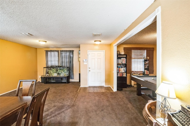 entryway featuring pool table, a textured ceiling, and dark carpet