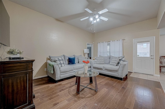 living room with ceiling fan and light wood-type flooring