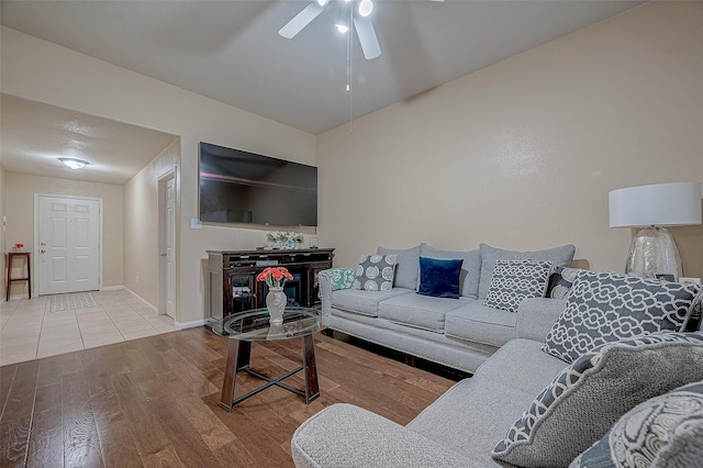 living room featuring ceiling fan and light wood-type flooring