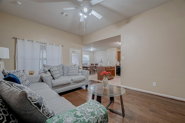 living room featuring light hardwood / wood-style floors and ceiling fan