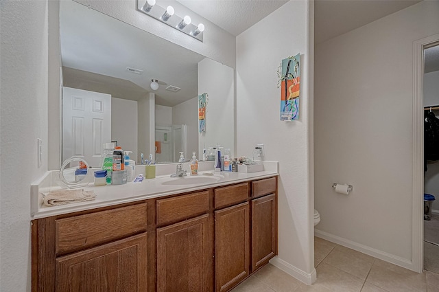 bathroom featuring tile patterned floors, toilet, and vanity