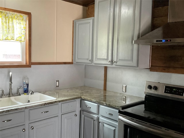 kitchen with white cabinetry, extractor fan, and stainless steel electric stove