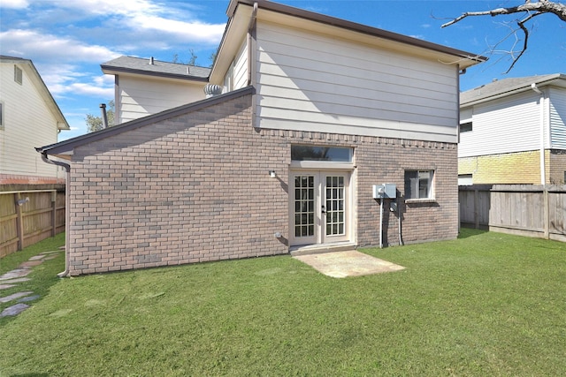 rear view of property with a lawn