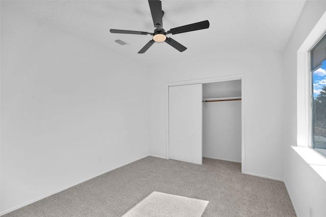 unfurnished bedroom featuring light colored carpet, a closet, and ceiling fan