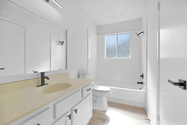 full bathroom with hardwood / wood-style flooring, vanity, a textured ceiling, toilet, and tiled shower / bath