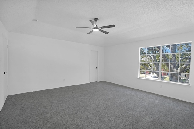 carpeted empty room featuring ceiling fan and a textured ceiling