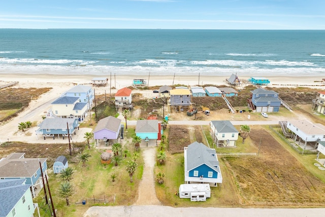 drone / aerial view featuring a water view and a beach view