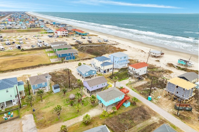 drone / aerial view with a water view and a beach view