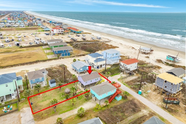 bird's eye view with a water view and a beach view