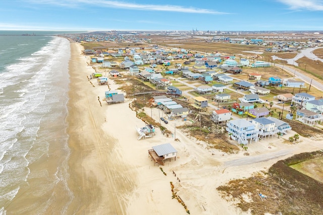 bird's eye view featuring a water view and a beach view