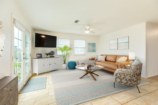 living room featuring light tile patterned flooring and ceiling fan