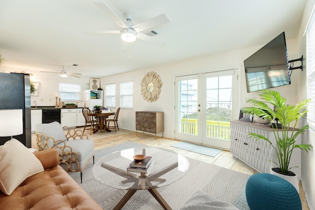 living room with light tile patterned flooring, sink, and ceiling fan