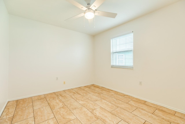 tiled spare room with ceiling fan