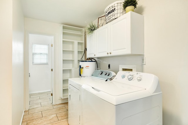 washroom with cabinets, washing machine and dryer, and water heater