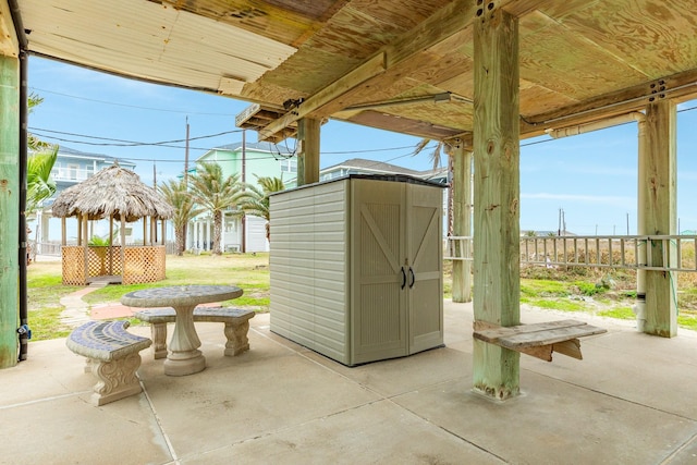 view of patio with a gazebo and a storage shed