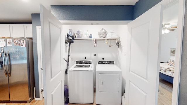 clothes washing area featuring separate washer and dryer, ceiling fan, and light wood-type flooring