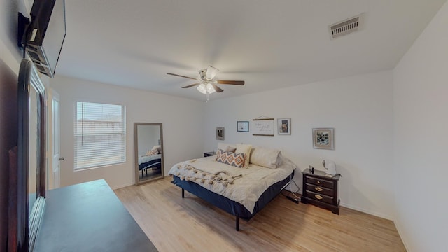 bedroom with ceiling fan and light hardwood / wood-style flooring