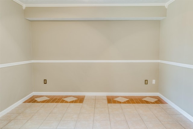 tiled spare room with crown molding