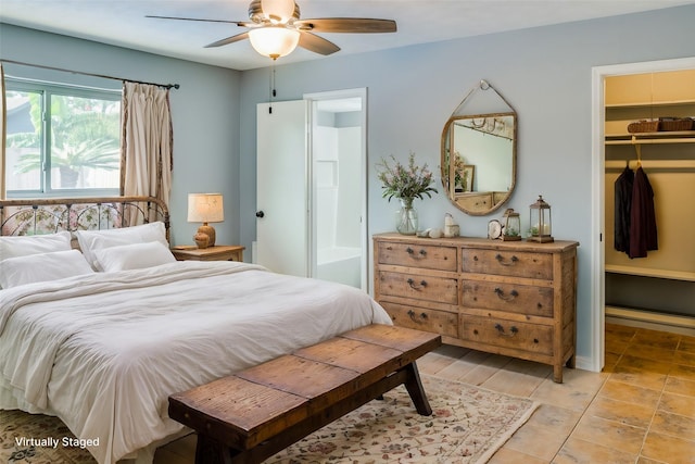 bedroom featuring a spacious closet, ensuite bath, a closet, and ceiling fan