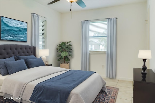 bedroom with ceiling fan and light tile patterned flooring