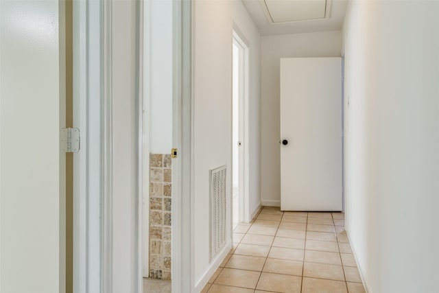 hall with light tile patterned floors