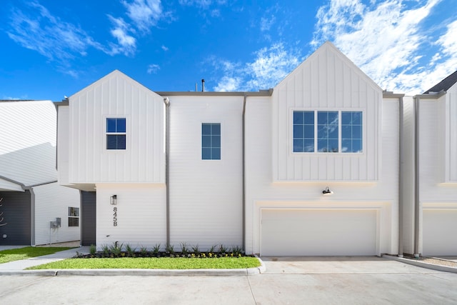 845 Elkhart St Unit B, Houston, TX 77091 - view of front facade featuring board and batten siding, an attached garage, and concrete driveway