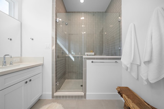 bathroom with vanity, tile patterned flooring, and a shower with shower door