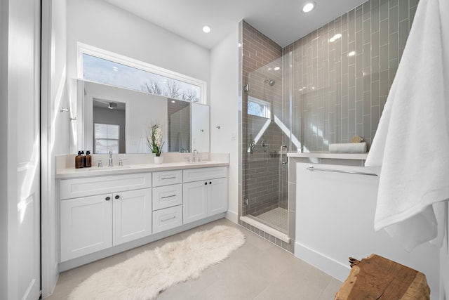 bathroom with vanity, a shower with shower door, and tile patterned flooring