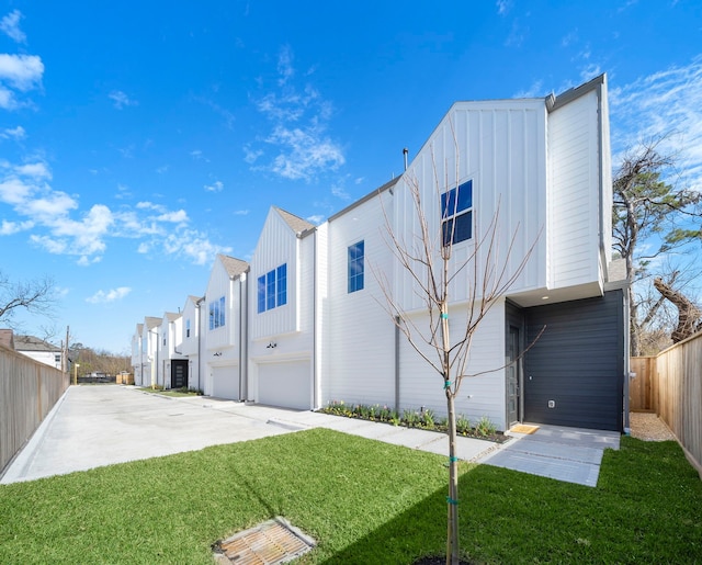 view of property exterior with a garage and a lawn