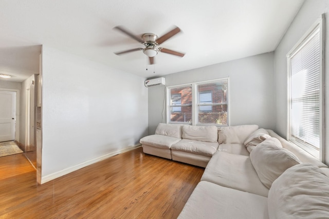 living room with ceiling fan, wood-type flooring, and a wall mounted AC