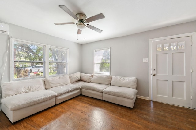 living room with dark wood-type flooring and ceiling fan