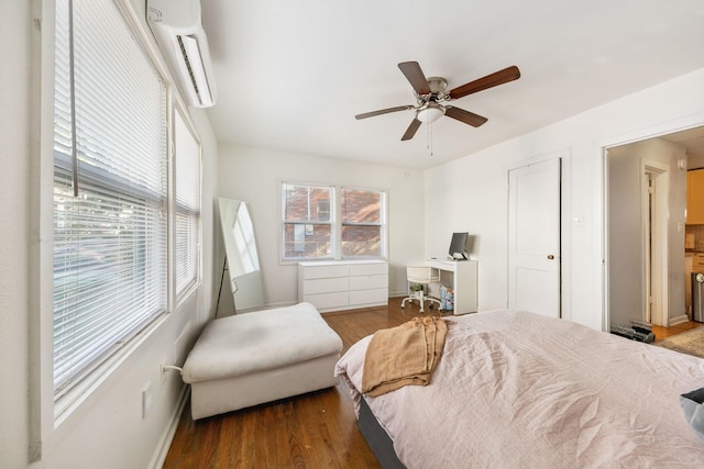 bedroom featuring dark wood-type flooring, an AC wall unit, and ceiling fan