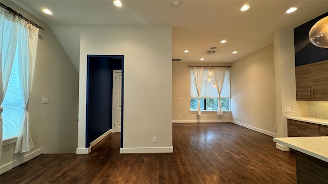 unfurnished living room with dark wood-type flooring