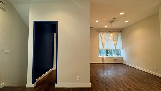 unfurnished room with dark wood-type flooring