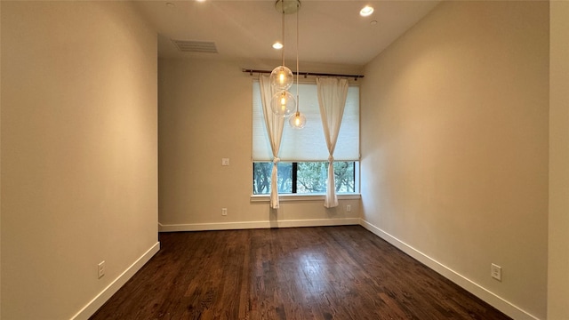 unfurnished room featuring dark hardwood / wood-style flooring