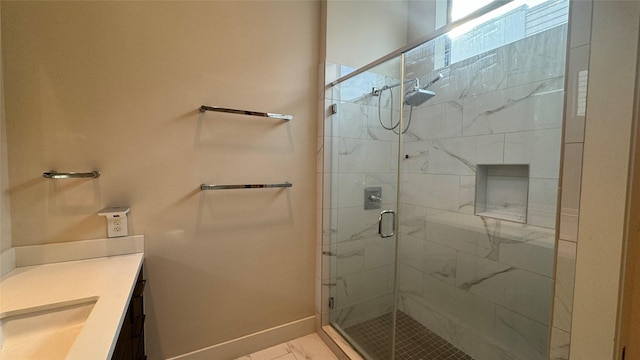 bathroom featuring vanity and a shower with door