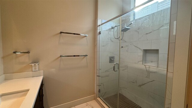 bathroom featuring vanity and an enclosed shower