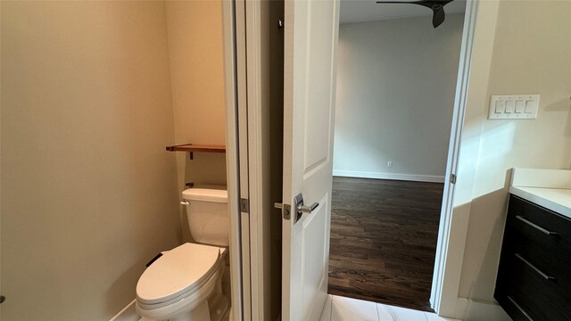 bathroom featuring hardwood / wood-style flooring, vanity, and toilet