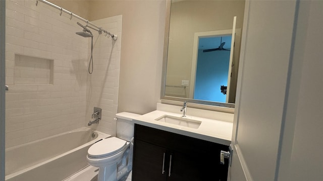 full bathroom with tiled shower / bath, vanity, and toilet