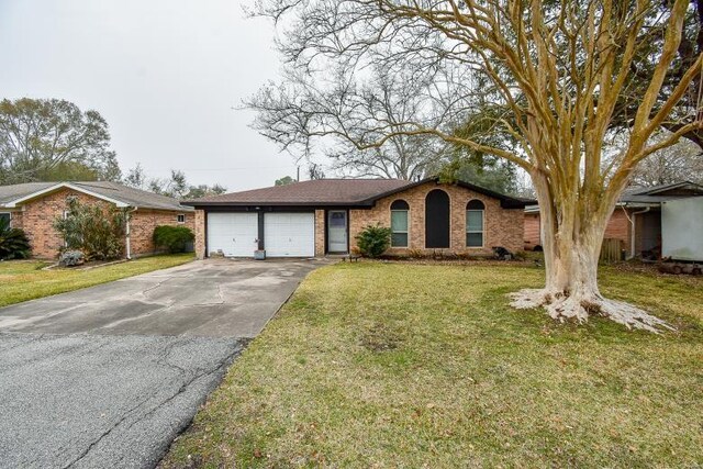 single story home with a garage and a front yard