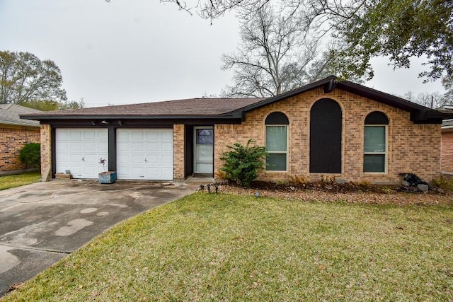 ranch-style house featuring a garage and a front lawn