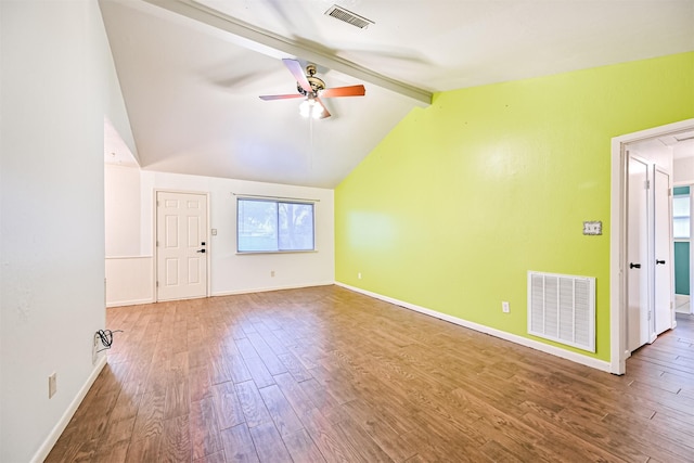 empty room with hardwood / wood-style flooring, ceiling fan, and vaulted ceiling with beams